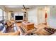 Comfortable living room with hardwood floors, a ceiling fan, a leather sofa, and a coffee table at 12992 State Hwy 160, Las Vegas, NV 89161