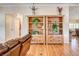 Cozy living room featuring built-in bookshelves, hardwood floors, and comfortable seating at 12992 State Hwy 160, Las Vegas, NV 89161