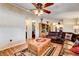 Inviting living room featuring hardwood floors, a leather sofa, and a rustic coffee table at 12992 State Hwy 160, Las Vegas, NV 89161