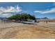 A serene horse paddock enclosed with sturdy fencing and shade trees with mountain views at 12992 State Hwy 160, Las Vegas, NV 89161