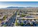 A neighborhood aerial view showing the home's proximity to the road, community, and distant mountains at 1304 Fantastic Ct, North Las Vegas, NV 89081