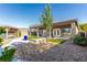 View of backyard landscaping from side yard, complete with covered patio and hot tub at 1304 Fantastic Ct, North Las Vegas, NV 89081