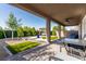 Covered patio and landscaped backyard featuring well-maintained lawn and a hot tub at 1304 Fantastic Ct, North Las Vegas, NV 89081