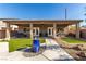 Spacious covered patio and backyard featuring well-maintained lawn and decorative fountain at 1304 Fantastic Ct, North Las Vegas, NV 89081