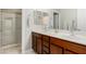 Bathroom featuring double sink vanity with granite countertops and walk-in shower at 1304 Fantastic Ct, North Las Vegas, NV 89081