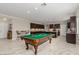 The billiards room leads into the open-concept kitchen, which features generous counter seating at 1304 Fantastic Ct, North Las Vegas, NV 89081