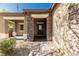 Stone entryway with covered porch and an ADT security system at 1304 Fantastic Ct, North Las Vegas, NV 89081