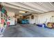 Spacious three car garage with shelving and storage, a classic car and ceiling storage at 1304 Fantastic Ct, North Las Vegas, NV 89081