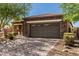 Two car garage with brick paved driveway and desert landscaping at 1304 Fantastic Ct, North Las Vegas, NV 89081