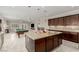 Chef's kitchen with large island, granite counters, and views of the living area and billiards at 1304 Fantastic Ct, North Las Vegas, NV 89081