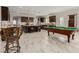Billiard room merges into a chef's kitchen with granite countertops and dark cabinetry at 1304 Fantastic Ct, North Las Vegas, NV 89081