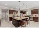 The large kitchen island features granite countertops and ample barstool seating at 1304 Fantastic Ct, North Las Vegas, NV 89081