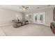Living room with neutral carpet, ceiling fan, and French doors to the backyard at 1304 Fantastic Ct, North Las Vegas, NV 89081