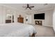 Cozy primary bedroom with a modern ceiling fan, a large television, and an ensuite bath at 1304 Fantastic Ct, North Las Vegas, NV 89081