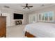 Spacious primary bedroom with carpet floors, french doors, and a large television at 1304 Fantastic Ct, North Las Vegas, NV 89081