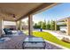 Inviting covered patio with comfortable seating and a beautiful landscaped backyard at 1304 Fantastic Ct, North Las Vegas, NV 89081