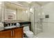 Modern bathroom with granite countertop, a glass shower, and a large mirror at 135 E Harmon Ave # 2702, Las Vegas, NV 89109