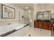 This clean bathroom features a tub, shower and lots of counter space at 135 E Harmon Ave # 2702, Las Vegas, NV 89109