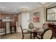 Cozy dining area featuring a glass-top table, comfortable seating, and a small kitchen in the background at 135 E Harmon Ave # 2702, Las Vegas, NV 89109