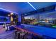 Modern game room featuring a golf simulation experience with city views at dusk at 135 E Harmon Ave # 2702, Las Vegas, NV 89109