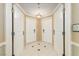 Inviting hallway featuring four white paneled doors and neutral tile flooring with decorative accents at 135 E Harmon Ave # 2702, Las Vegas, NV 89109