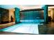 Inviting indoor pool area with tiled walls, a calming waterfall feature, and stainless steel rails at 135 E Harmon Ave # 2702, Las Vegas, NV 89109