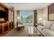 Well-lit living area offering comfortable seating, tasteful decor, and a scenic outdoor view from the balcony at 135 E Harmon Ave # 2702, Las Vegas, NV 89109