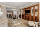 Open-concept living area with built-in cabinetry, a dining table set, and a partial view of the kitchen at 135 E Harmon Ave # 2702, Las Vegas, NV 89109