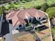 Aerial view displaying an estate with a beautiful front yard, and landscaping and a gorgeous red tile roof at 1429 Iron Hills Ln, Las Vegas, NV 89134
