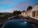 An amazing backyard with a pool, spa and desert landscaping offer a tranquil escape with mountain views at 1429 Iron Hills Ln, Las Vegas, NV 89134
