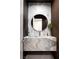 Bathroom featuring a marble vanity with a round mirror, contrasting dark trim, and a modern faucet at 1429 Iron Hills Ln, Las Vegas, NV 89134