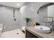 Bathroom featuring a neutral vanity with a round mirror and a walk-in shower with gray square tiling at 1429 Iron Hills Ln, Las Vegas, NV 89134