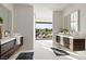 Luxurious bathroom with dual sink vanities and sliding glass doors with outdoor views at 1429 Iron Hills Ln, Las Vegas, NV 89134