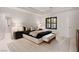 Bright bedroom with tray ceilings, an ensuite bathroom, and contemporary decor at 1429 Iron Hills Ln, Las Vegas, NV 89134