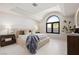 Bright bedroom with arched windows, tray ceilings, and modern decor at 1429 Iron Hills Ln, Las Vegas, NV 89134