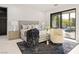 Modern bedroom with plush decor, a sliding glass door, and view of the outdoor living space at 1429 Iron Hills Ln, Las Vegas, NV 89134