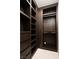Walk-in closet with custom dark brown wood shelving and drawers for organization and storage at 1429 Iron Hills Ln, Las Vegas, NV 89134