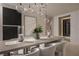 Modern dining room with elegant lighting, contemporary art, and a temperature-controlled wine storage unit at 1429 Iron Hills Ln, Las Vegas, NV 89134