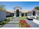 The front exterior of the property features a meticulously landscaped yard with a seating area at 1429 Iron Hills Ln, Las Vegas, NV 89134