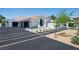 Front exterior showcasing a well manicured front yard and a long driveway at 1429 Iron Hills Ln, Las Vegas, NV 89134