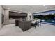 Modern kitchen featuring a large island, sleek cabinetry, and a seamless connection to outdoor views at dusk at 1429 Iron Hills Ln, Las Vegas, NV 89134