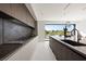 Modern kitchen featuring a large island, sleek cabinetry, and a seamless connection to outdoor views at 1429 Iron Hills Ln, Las Vegas, NV 89134
