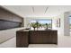 Modern kitchen featuring a large island, sleek cabinetry, and a seamless connection to outdoor views at 1429 Iron Hills Ln, Las Vegas, NV 89134