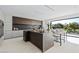 Modern kitchen featuring a large island, sleek cabinetry, and a seamless connection to outdoor views at 1429 Iron Hills Ln, Las Vegas, NV 89134