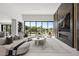 Bright open living room featuring modern furnishings, fireplace, and expansive views of the golf course at 1429 Iron Hills Ln, Las Vegas, NV 89134
