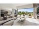Bright living room featuring modern furnishings and expansive views of the golf course at 1429 Iron Hills Ln, Las Vegas, NV 89134