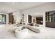 Spacious open-concept living room showcasing modern furnishings and seamless transitions to dining and kitchen areas at 1429 Iron Hills Ln, Las Vegas, NV 89134