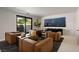 Modern living room with four armchairs, dark media center, and sliding doors leading to the exterior at 1429 Iron Hills Ln, Las Vegas, NV 89134