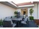 Cozy outdoor dining area with a dark table set and stylish lanterns near bright flowers at 1429 Iron Hills Ln, Las Vegas, NV 89134