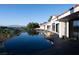 Stunning backyard pool and patio area of this home with mountain views in the distance at 1429 Iron Hills Ln, Las Vegas, NV 89134